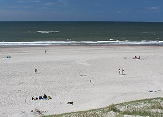 A summer day with bathers on the wide sandy beach in Haurvig A summer day with bathers on the wide sandy beach in Haurvig