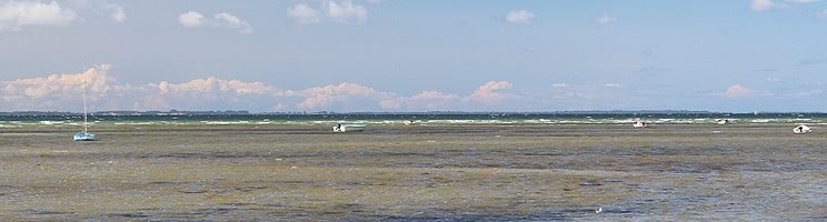 Small boats on the shallow bathing water by the holiday home area Over Dråby Strand Small boats on the shallow bathing water by the holiday home area Over Dråby Strand