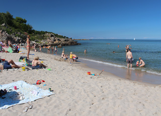 The lovely bathing beach with child-friendly water in Sandkås is surrounded by cliffs The lovely bathing beach with child-friendly water in Sandkås is surrounded by cliffs