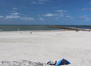 Ein Sommertag am breiten Sandstrand mit der Mole in Hvide Sande Ein Sommertag am breiten Sandstrand mit der Mole in Hvide Sande