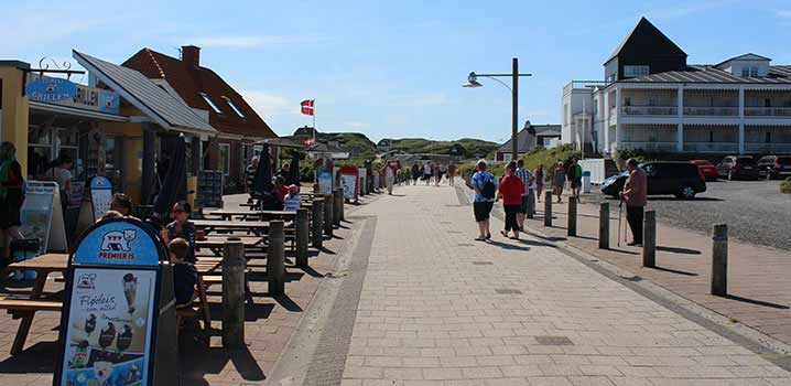 Enjoy  your holiday with a lovely ice cream and a nice stroll in the town. Pedestrian street with  ice cream stalls and shops to the left, holiday flats to the right and dunes in the back.